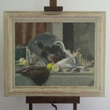 Framed still life painting on an easel against a white wall